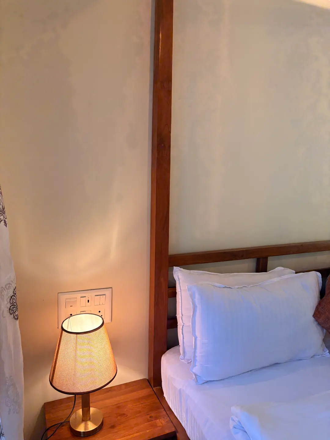 Bedroom with a wooden four-poster bed at The Coastal Heritage, Alibag