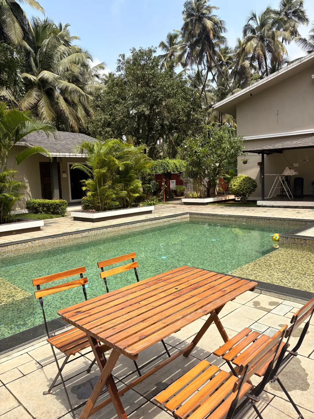 Swimming pool with sun loungers at The Coastal Heritage resort, Alibag