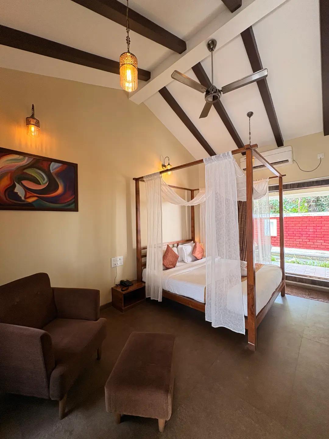 Four-poster bed with white drapes in a room at The Coastal Heritage