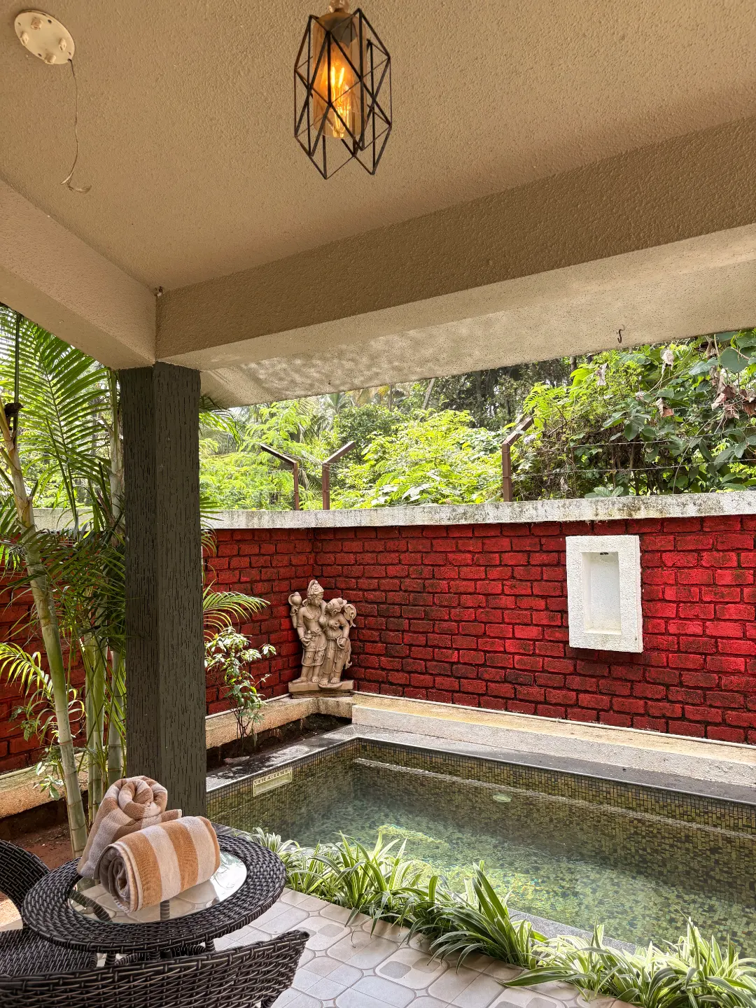 Private sit-out with red brick wall and garden at The Coastal Heritage