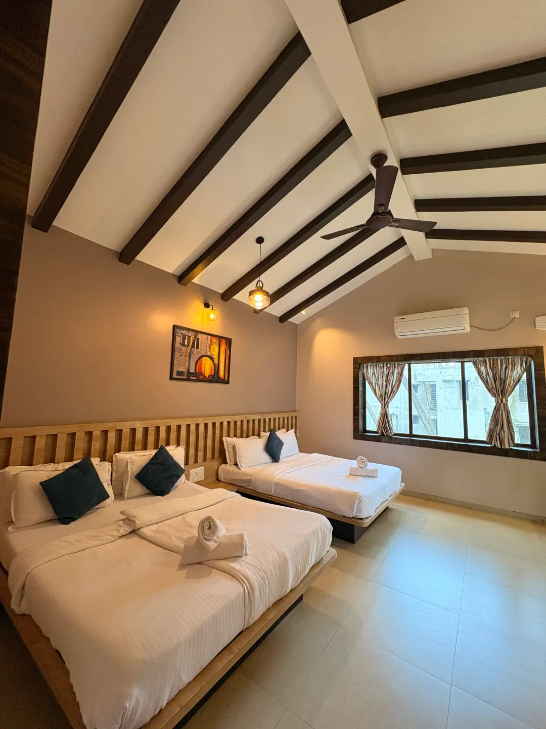 Twin-bed room with wooden ceiling beams at The Coastal Heritage